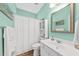 Bathroom with light green walls, shower with a white curtain, and a large mirror at 9616 Pebble Creek Blvd, Summerville, SC 29485