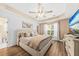 This bedroom features a ceiling fan, a decorative tray ceiling, wood-look floors, and a large bed at 9616 Pebble Creek Blvd, Summerville, SC 29485