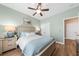 Bedroom with light green walls, wood look flooring, ceiling fan, and a large bed at 9616 Pebble Creek Blvd, Summerville, SC 29485
