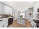 Airy kitchen featuring wood floors, white cabinets and island with breakfast bar seating at 9616 Pebble Creek Blvd, Summerville, SC 29485