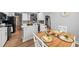 Open kitchen and dining area with light wood floors and white cabinets at 9616 Pebble Creek Blvd, Summerville, SC 29485