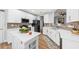 Modern kitchen with white cabinets, a center island, and stainless steel appliances, perfect for culinary enthusiasts at 9616 Pebble Creek Blvd, Summerville, SC 29485