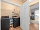 This laundry room has storage shelves above a washer and dryer at 9616 Pebble Creek Blvd, Summerville, SC 29485