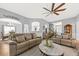 Spacious living room featuring stylish furnishings, a ceiling fan, and an open layout perfect for entertaining at 9616 Pebble Creek Blvd, Summerville, SC 29485