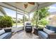 Screened patio area featuring comfortable seating and views of the backyard at 9616 Pebble Creek Blvd, Summerville, SC 29485