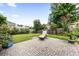 Backyard patio features brick pavers and lounge seating surrounded by manicured plants at 9616 Pebble Creek Blvd, Summerville, SC 29485