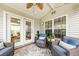 Relaxing covered outdoor patio area with comfortable seating and ceiling fan at 9616 Pebble Creek Blvd, Summerville, SC 29485