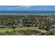 Aerial view of the property highlighted by a red arrow, in a community near the ocean and a golf course at 10 Chapman Ave, Isle of Palms, SC 29451