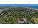 Aerial view of the property near the ocean, a river and a golf course, indicated by a red arrow at 10 Chapman Ave, Isle of Palms, SC 29451