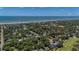 Aerial view of a neighborhood with a red arrow indicating the property's location near the ocean at 10 Chapman Ave, Isle of Palms, SC 29451