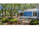 Backyard featuring blue siding, screened in porch, deck, and lush landscaping at 10 Chapman Ave, Isle of Palms, SC 29451