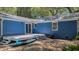Backyard featuring blue siding, deck with steps and lush landscaping at 10 Chapman Ave, Isle of Palms, SC 29451