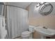 Cozy full bathroom with shower and tub, vanity and a round mirror at 10 Chapman Ave, Isle of Palms, SC 29451