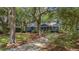 Charming blue home with a well-maintained lawn and mature trees at 10 Chapman Ave, Isle of Palms, SC 29451