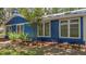 Exterior view of a blue home with white trim, showcasing its well-maintained facade and landscaping at 10 Chapman Ave, Isle of Palms, SC 29451