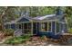 Cozy blue house featuring a screened porch and well-kept landscaping at 10 Chapman Ave, Isle of Palms, SC 29451