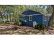 Home exterior with blue siding, propane tank, and lush greenery at 10 Chapman Ave, Isle of Palms, SC 29451
