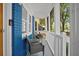 Inviting front porch with stylish wicker chairs and blue painted brick accent wall at 10 Chapman Ave, Isle of Palms, SC 29451
