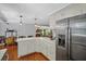 Bright kitchen with stainless steel refrigerator and open view to the cozy living room with fireplace at 10 Chapman Ave, Isle of Palms, SC 29451
