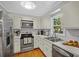 Traditional kitchen featuring stainless steel appliances and hardwood flooring, with a garden window at 10 Chapman Ave, Isle of Palms, SC 29451