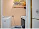 A small laundry room with a washer, dryer, and storage shelves at 10 Chapman Ave, Isle of Palms, SC 29451