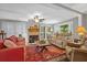 Bright living room featuring a fireplace, ceiling fan and plenty of seating at 10 Chapman Ave, Isle of Palms, SC 29451
