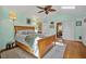Light-filled primary bedroom with a ceiling fan, private patio access and ensuite bathroom at 10 Chapman Ave, Isle of Palms, SC 29451