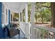 Charming screened porch with comfortable seating and views of the landscaped front yard at 10 Chapman Ave, Isle of Palms, SC 29451