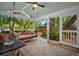Relaxing screened porch with comfortable swing, ceiling fan, and inviting outdoor decor at 10 Chapman Ave, Isle of Palms, SC 29451