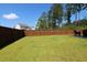 Spacious, well-maintained backyard with lush green grass and privacy fence, offering ample space for outdoor activities at 103 Granton Edge Ln, Summerville, SC 29486