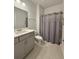 Modern bathroom featuring a shower stall, a gray vanity, a large mirror, and neutral-colored tiles at 103 Granton Edge Ln, Summerville, SC 29486