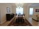 Formal dining room featuring a chandelier, a large window, and an elegant table with seating for six at 103 Granton Edge Ln, Summerville, SC 29486