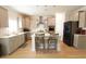 Well-equipped kitchen featuring modern appliances, gray cabinets, and an island with bar seating at 103 Granton Edge Ln, Summerville, SC 29486