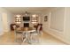 Cozy living room with built-in shelves, a fireplace, hardwood floors, and a round table with chairs at 103 Granton Edge Ln, Summerville, SC 29486