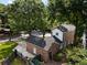 Aerial view of a brick home with mature trees and a fenced backyard at 1067 Loyalist Ln, Mount Pleasant, SC 29464