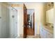Bright bathroom featuring a glass-enclosed shower, vanity, and open doorway at 1067 Loyalist Ln, Mount Pleasant, SC 29464