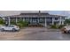 Elegant clubhouse with landscaped entrance, featuring a water feature and covered balconies at 1067 Loyalist Ln, Mount Pleasant, SC 29464
