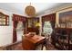 Inviting dining area featuring vintage decor, elegant curtains, and unique lighting at 1067 Loyalist Ln, Mount Pleasant, SC 29464