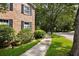 Brick home showcasing manicured landscaping and a peaceful sidewalk at 1067 Loyalist Ln, Mount Pleasant, SC 29464