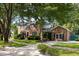 Beautiful two-story brick home with mature trees, manicured lawn, and classic shutters at 1067 Loyalist Ln, Mount Pleasant, SC 29464