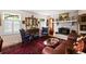 Elegant living room with fireplace, antique furniture, and bright windows at 1067 Loyalist Ln, Mount Pleasant, SC 29464