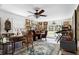 Spacious home office filled with natural light, antique furniture, and a decorative ceiling fan at 1067 Loyalist Ln, Mount Pleasant, SC 29464