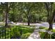 Scenic street view with mature trees and a well-maintained sidewalk at 1067 Loyalist Ln, Mount Pleasant, SC 29464