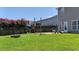 A fenced backyard with a seating area, fire pit, and flourishing pink flowers at 112 Worthington Dr, Moncks Corner, SC 29461