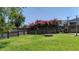 Green fenced-in backyard featuring vibrant blooming flowers and a cozy fire pit at 112 Worthington Dr, Moncks Corner, SC 29461