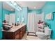 Bright blue bathroom featuring a double vanity, tile flooring, and neutral shower curtain at 112 Worthington Dr, Moncks Corner, SC 29461