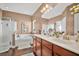Bright bathroom with double sink vanity, separate tub, and glass-enclosed shower at 112 Worthington Dr, Moncks Corner, SC 29461