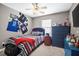 Decorated bedroom featuring sports jerseys, ceiling fan and a comfortable bed at 112 Worthington Dr, Moncks Corner, SC 29461