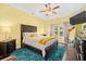 Comfortable bedroom featuring a tray ceiling, ceiling fan and a cozy bed at 112 Worthington Dr, Moncks Corner, SC 29461