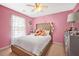 Pink bedroom with a tufted headboard bed, lots of natural light, and a ceiling fan at 112 Worthington Dr, Moncks Corner, SC 29461